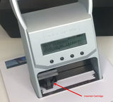 A close-up of a silver electronic testing device with a digital display screen and an open lower compartment showing an inserted cartridge, with a red arrow and text label pointing to it.